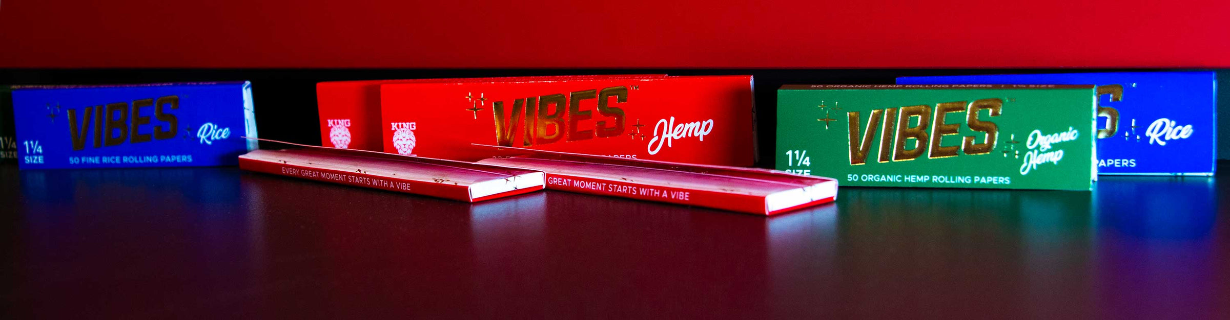 Got Vape Retail Vibes Papers laying down on table with red background.