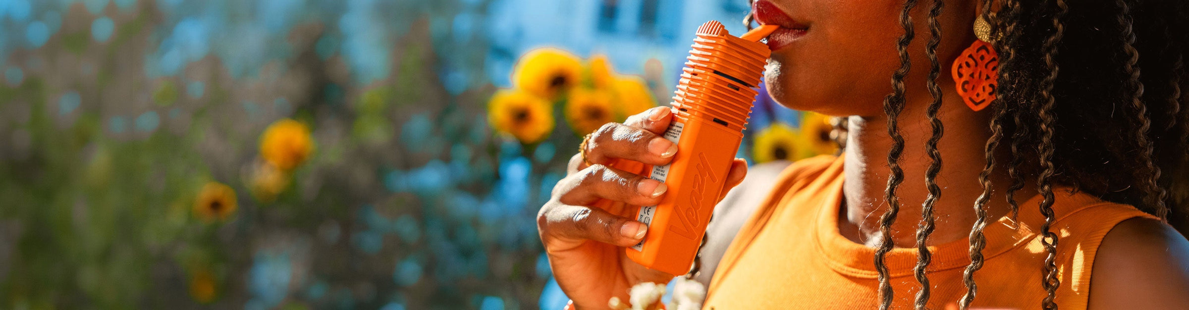 Woman holding Storz & Bickel Veazy in sunflower field